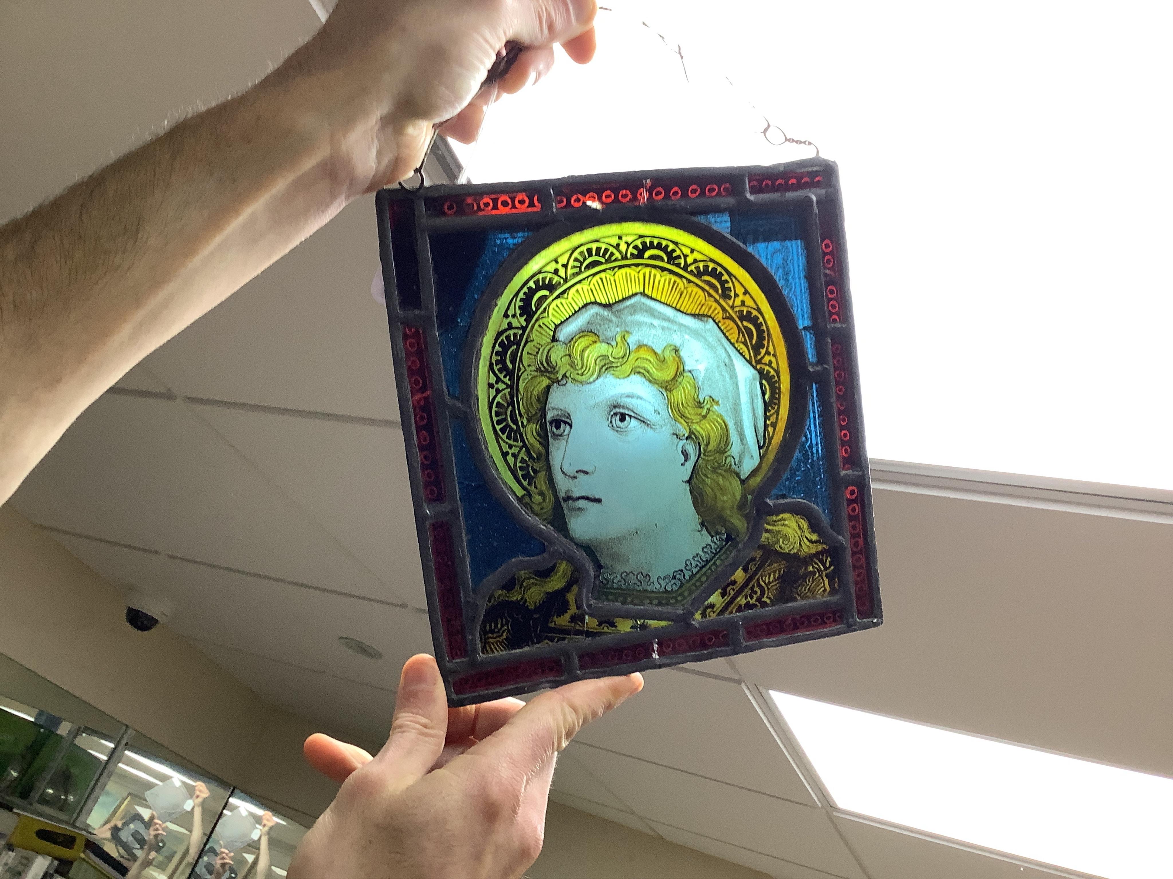 A stained glass panel showing the head of a saint, 21 x 20cm. Condition - four panels cracked